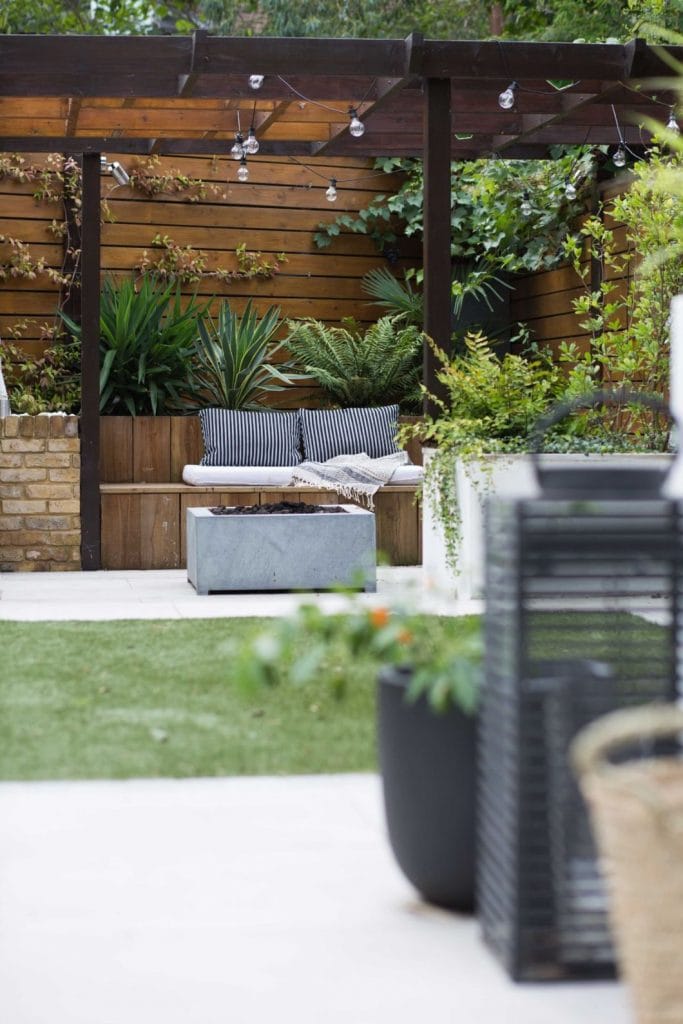 Garden design Surrey with black timber pergola, hardwood decking and corten planters