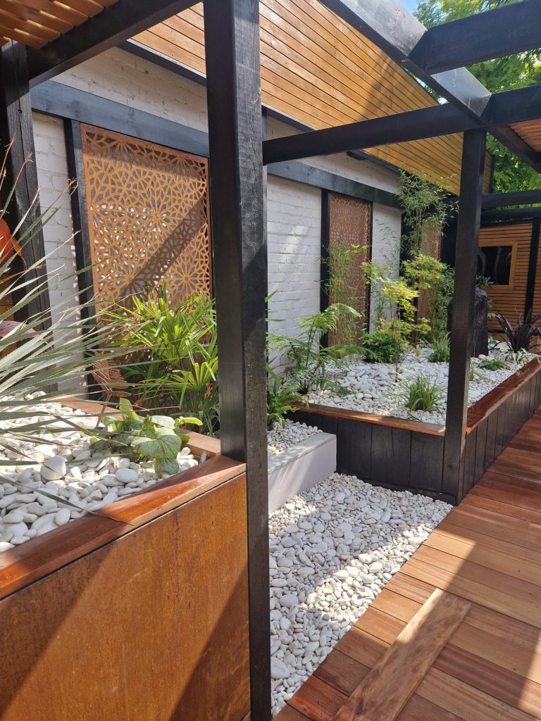 Expert consultant from Taylored Gardens discussing custom garden design plans with a client