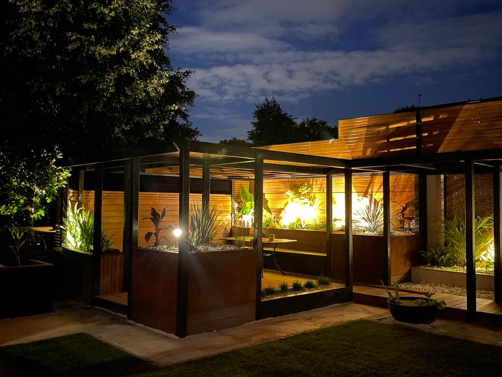 Garden lawn beside pergola-covered seating, raised planters and a timber walkway - Teddington garden design