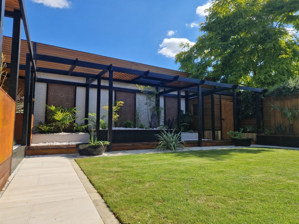 Garden construction with timber pergola, raised planters, lawn and paved seating
