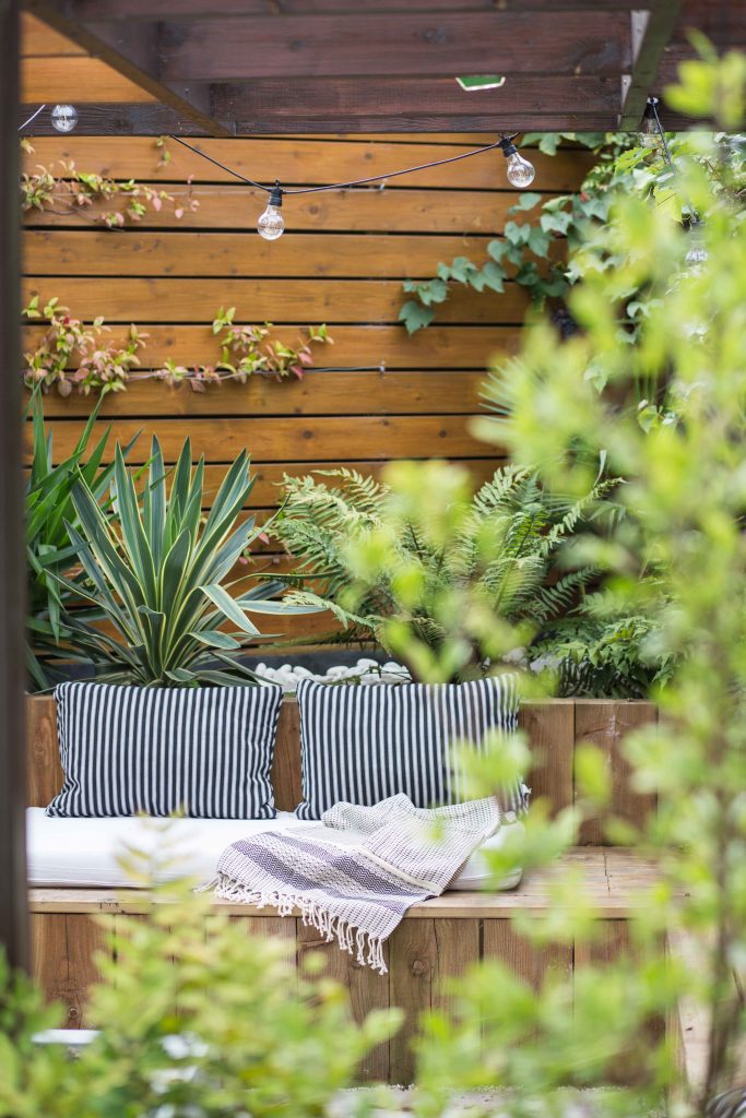 Expert consultant from Taylored Gardens discussing custom garden design plans with a client