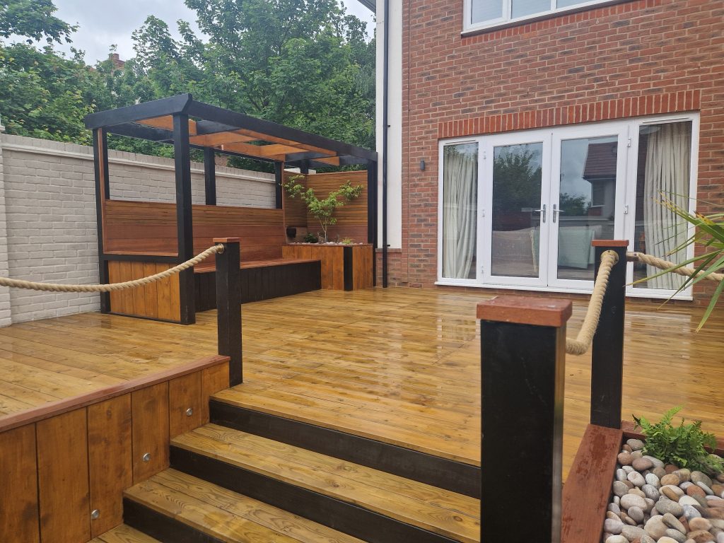 Raised timber deck with steps, rope handrails and a covered structure beside the house