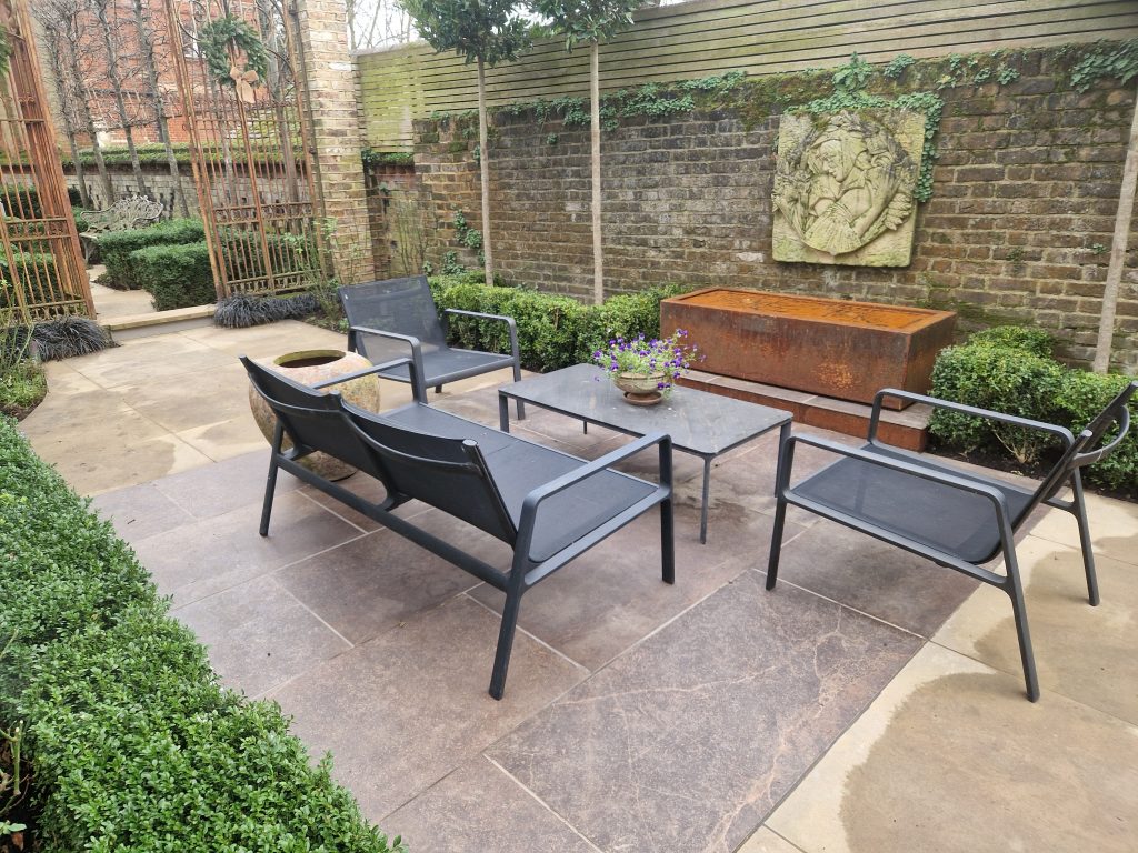 Garden design and build with timber pergola, built-in bench and brick-edged beds