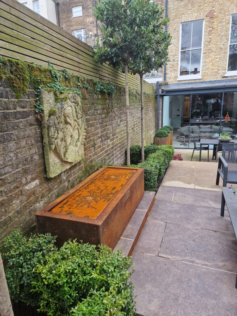 Garden design Surrey courtyard with painted pergola and outdoor seating